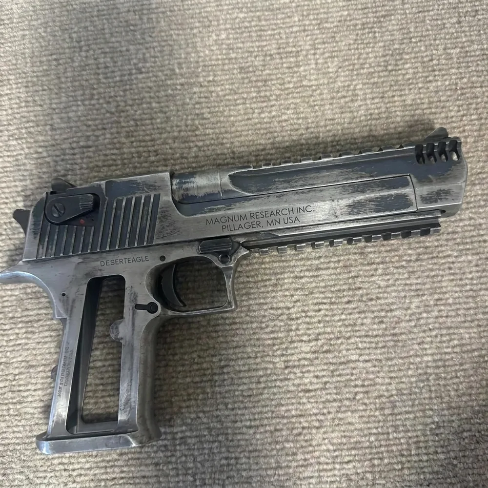 Before: worn bare-metal pistol
