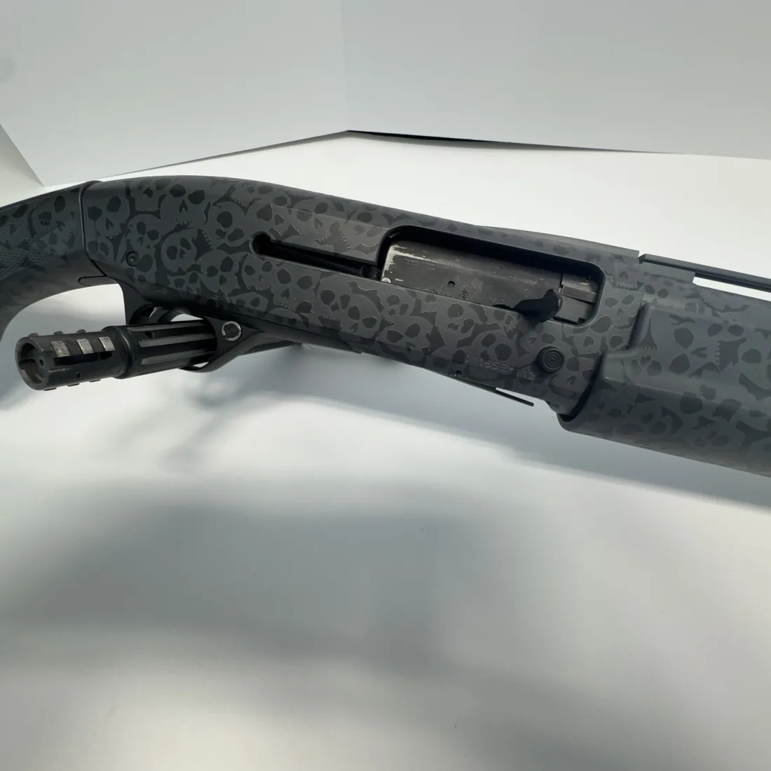 Skull-pattern Cerakote finish on a shotgun