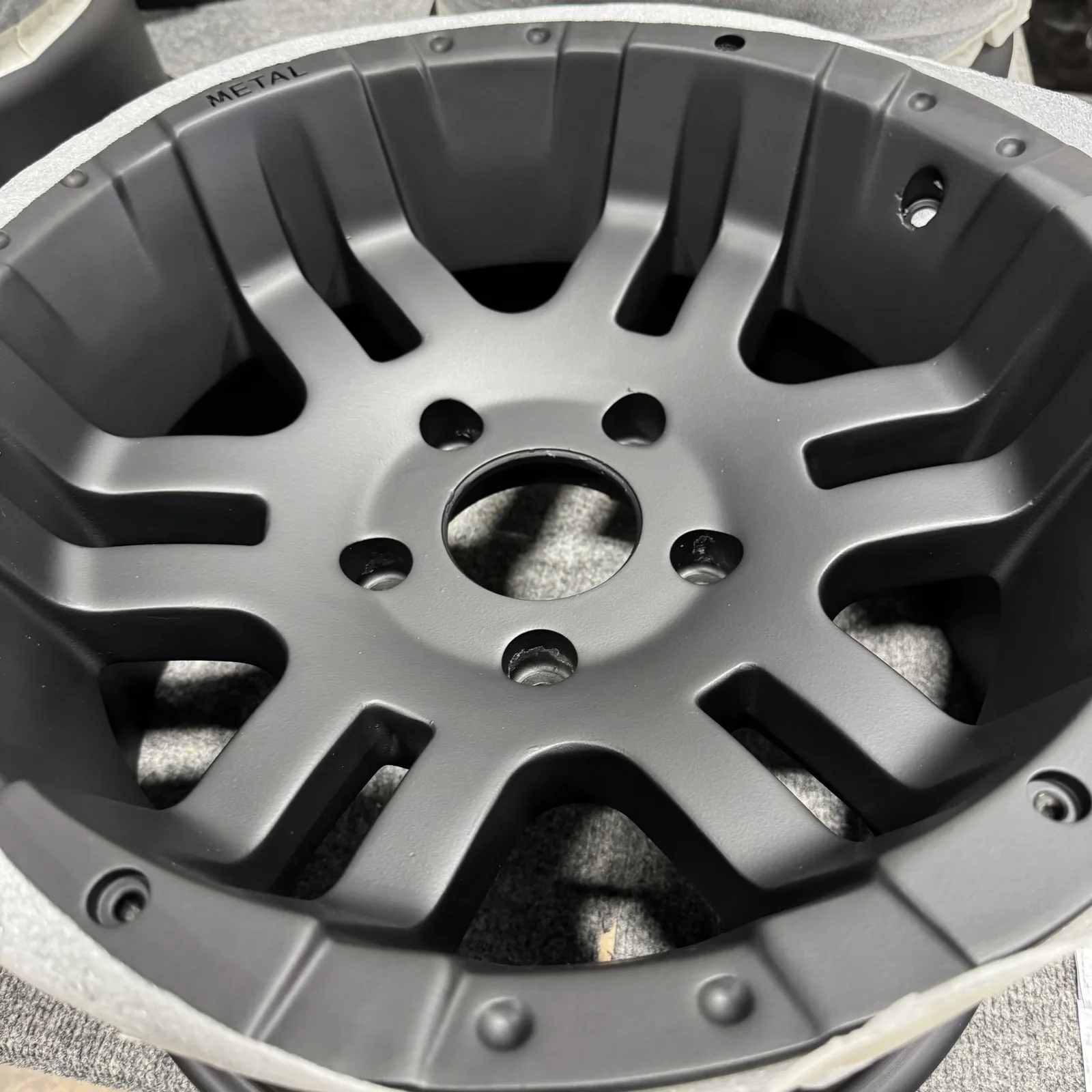 After: matte black powder-coated wheel